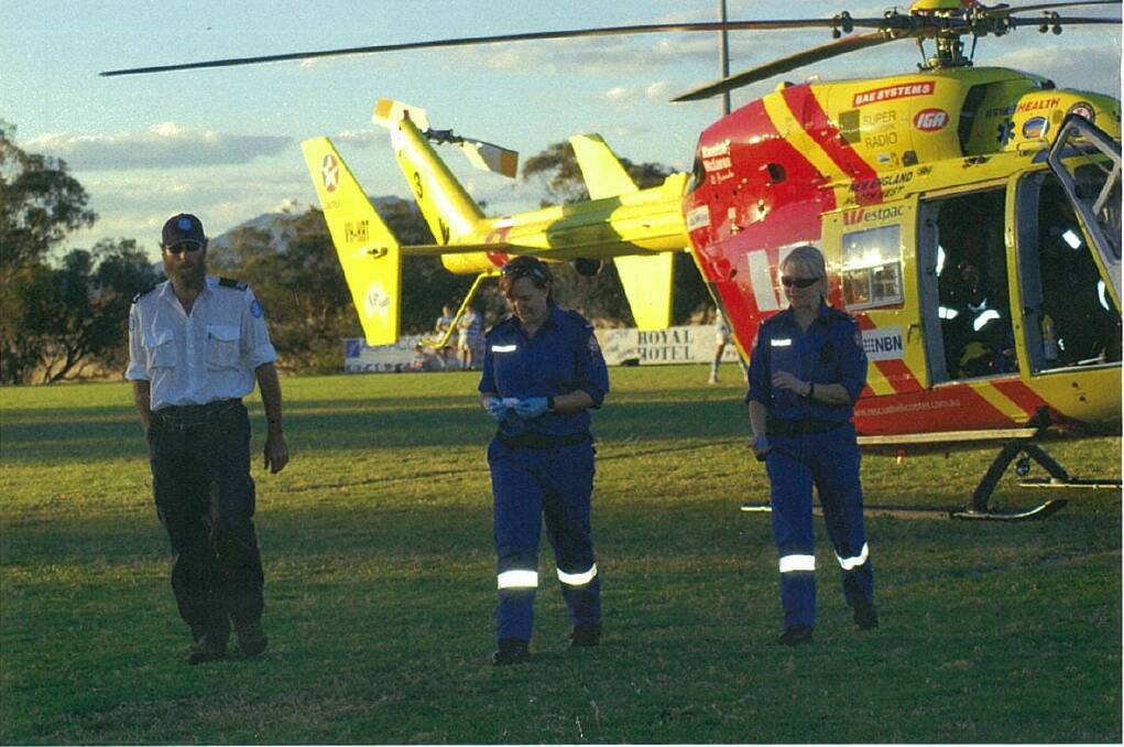 ABOVE: Nicole Beacroft and her station officer Megan Kerslake in 2008, attending to a spinal injury during a rugby game at Quirindi.