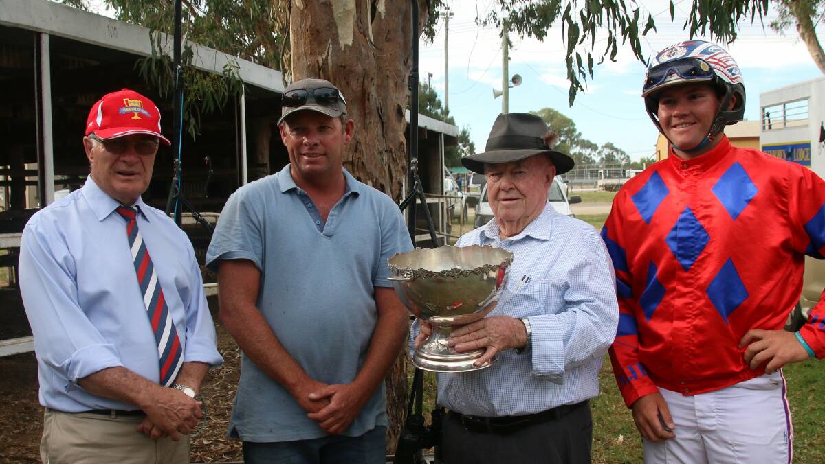 ALL SMILES: Chris Edwards HRNSW Board Member, trainer Mark "Jack Butler" Inverell local identity Brian Baldwin holding the 45 year old KATO Perpetual Trophy and reinsman Nathan Dawson.