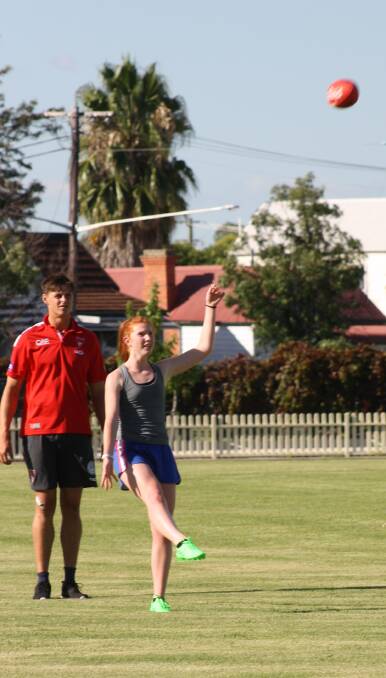 On her way: Elle Ford training earlier this year with Sydney Swans superstar Callum Sinclair. Picture: contributed
