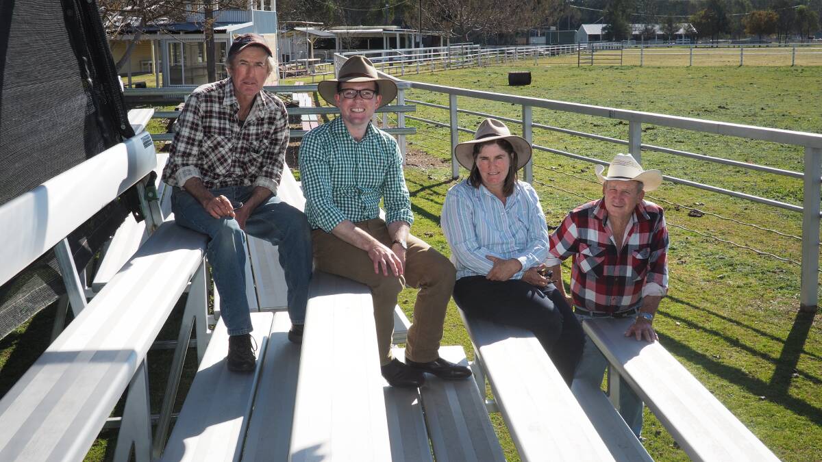 Northern Tablelands MP Adam Marshall enjoys the shade in one of Ashford Showground’s portable grandstands with Ashford Showground Trust members Gilbert Fitzhannim, left, Roxanne Geach and Bill Irwin.