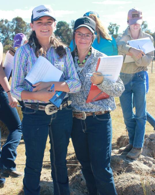 Macintyre High School students from Inverell, Taylor Withers (left) and Amy Whitechurch (right), take notes at the soil pit.