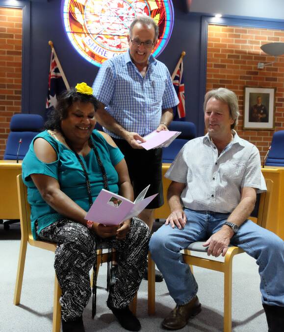 GIFT OF HISTORY: Poet Esther Gardiner with her book, and Inverell deputy mayor Cr Anthony Michael and Cr Paul King in the shire chambers where citizenship ceremonies take place.