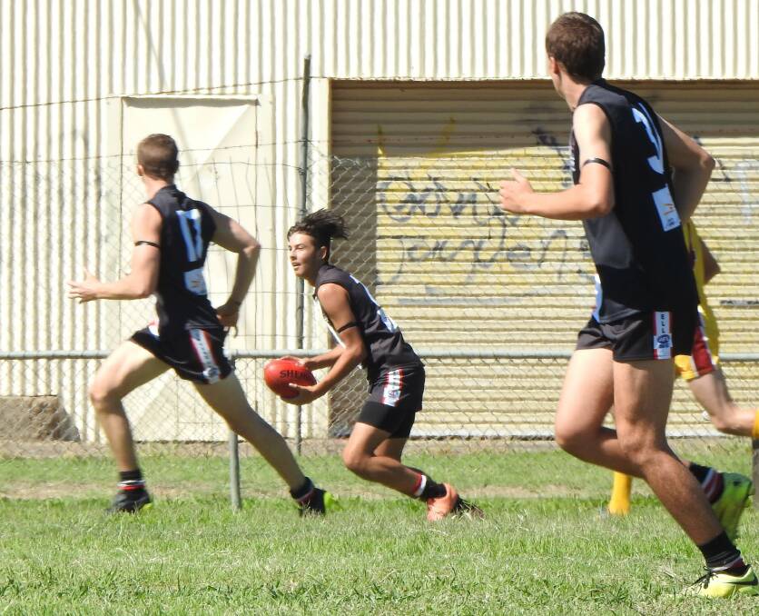 GOOD BEGINNING: Senior side debutante Josh Desborough runs clear of the opposition, with Jake Cannon and Ben Ellis in support. Photo contributed by Sonia Martin