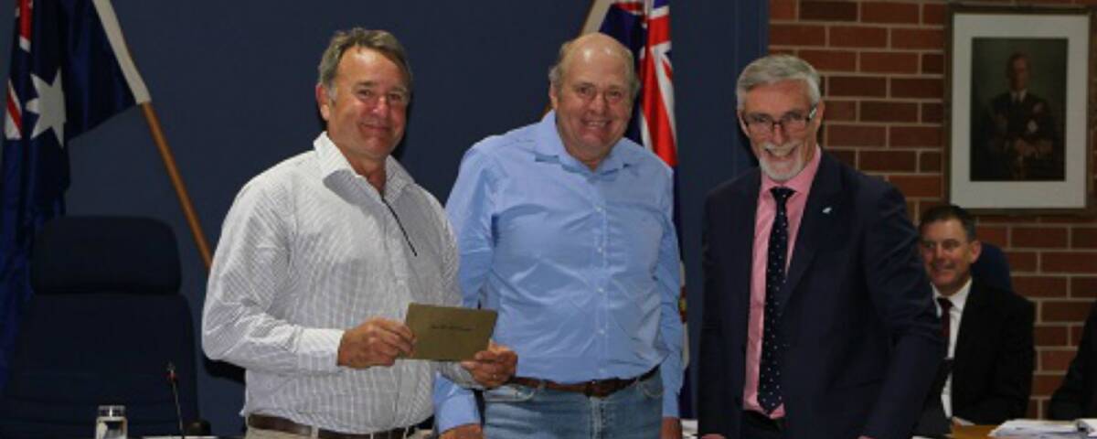 Good Start: Gum Flat Hall committee members Steve Auld and Wayne Mudford are presented with a $2000 cheque by mayor Paul Harmon.