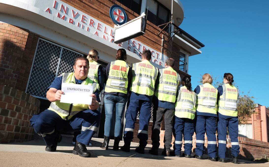 WHERE IT BEGAN: The July 2016 silent protest about the entitlements slash, when NSW ambulance officers inserted an 'Unprotected' sign in their fluro vests. Photo: Michèle Jedlicka
