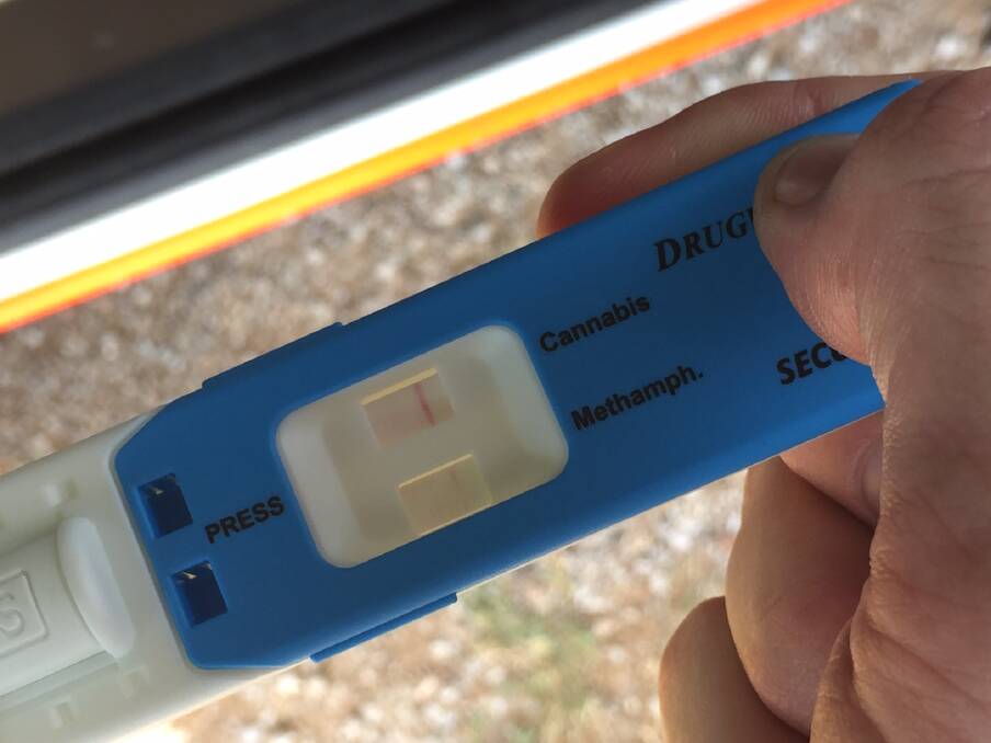 Random test: Police watch a sample for traces of drugs after testing a driver. Photo: Breanna Chillingworth