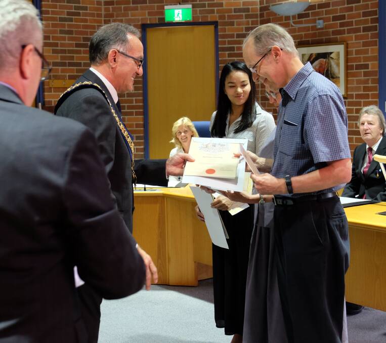 BESTOWED: Cr Michael presents Bill Wiser with his certificate of Australian citizenship.