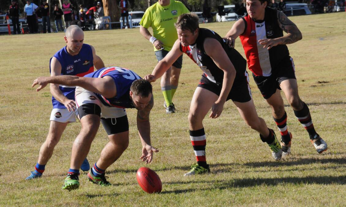 Gunnedah's Matthew Pengilly leads the chase for the ball as he reaches to field it for the Bulldogs AFC against the Saints.
