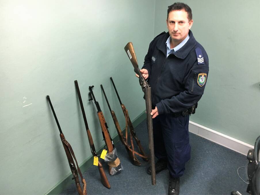No charge: Sgt Tim Mowle with a handful of the weapons surrendered to Inverell Police under the amnesty. Photo Heidi Gibson