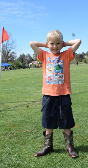 Noah enjoys the attention at the Mini World Cup. He had the perfect boots for the soggy ground. Photos: Merilyn Vale