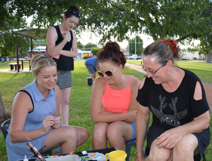 Tiana Cooper, Samaria Kennedy and Kay Riley get ready to paint faces, with Jodie Holder looking on.