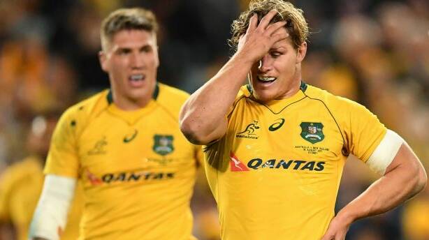 Tough night at the office: Michael Hooper reacts to another All Blacks try. He was criticised for finding the positives from Australia's second-half comeback. Photo: DEAN LEWINS