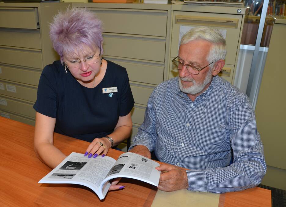 Fascinating: Library manager Sonya Lange and Delungra Development Council chair Peter McCarthy explore the book.