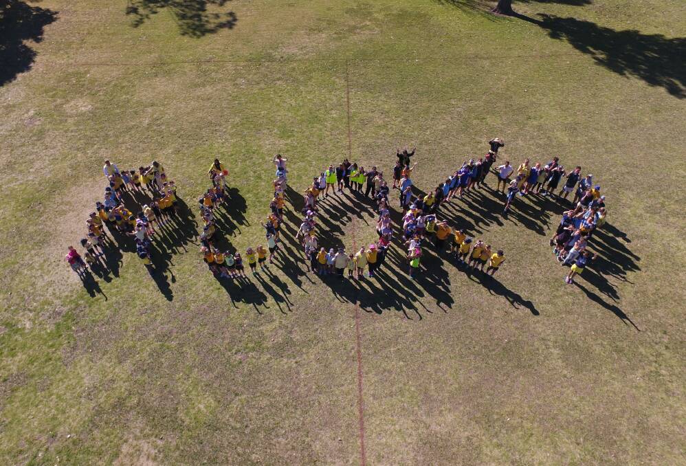 Working together: Bingara Central School thoroughly embraced the mental health message, with the whole school spelling out RUOK? on Friday. If you're struggling, contact Lifeline on 13 11 14.