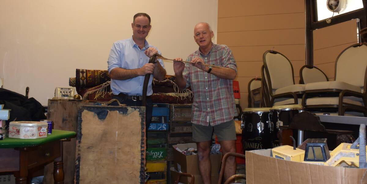 Inverell Club president Dayne Rosolen and antique show organiser Tony Sonter surrounded by the eclectic collection set to go on sale.