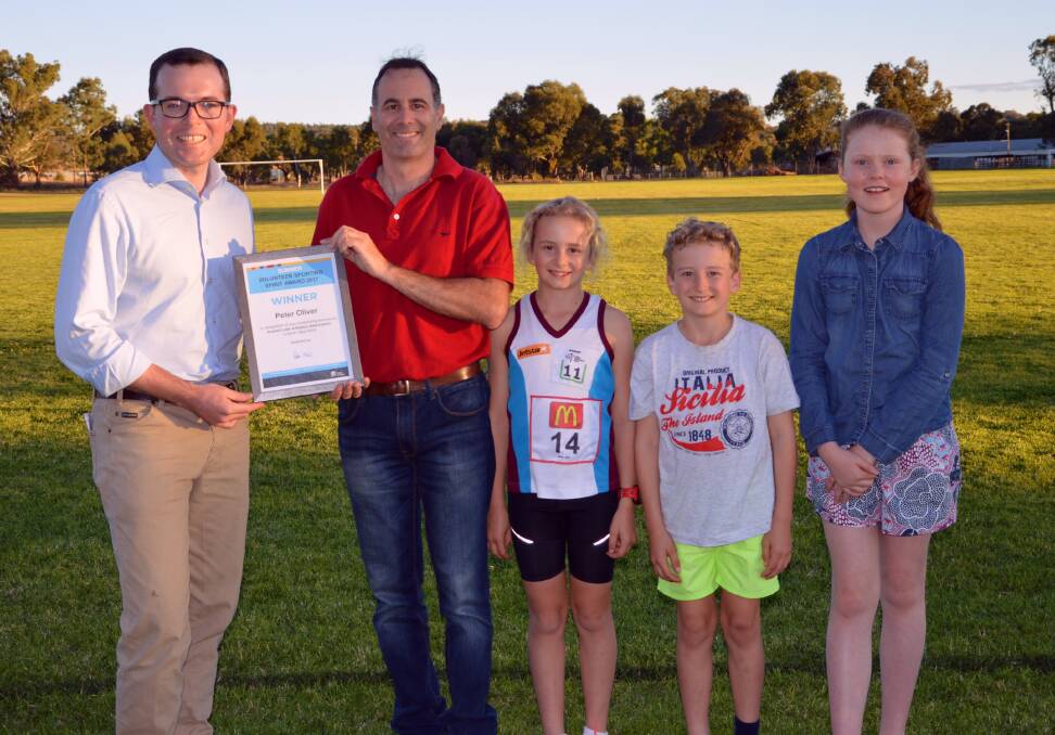 Northern Tablelands MP Adam Marshall presents Inverell volunteer Peter Oliver with his award alongside young sports stars Matilda Oliver, Henry Oliver and Prudence Black.