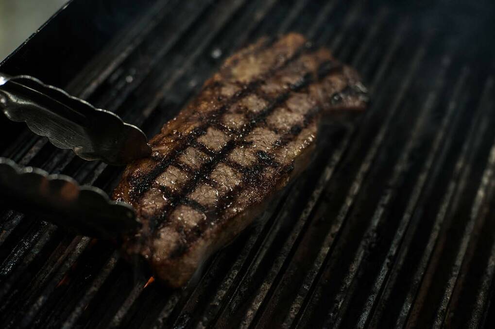 Grill steak to your liking: three minutes each side for a rare steak, a further minute each side for medium, or a further three minutes (six in total each side) for well done. Photo: Josh Robenstone/Getty Images