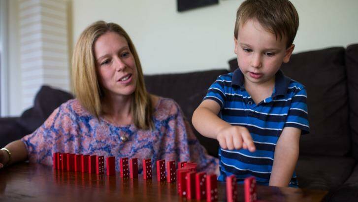 Rebecca O'Neil with son Connor , 5, counting dominos and learning to solve problems with building blocks. Photo: Edwina Pickles