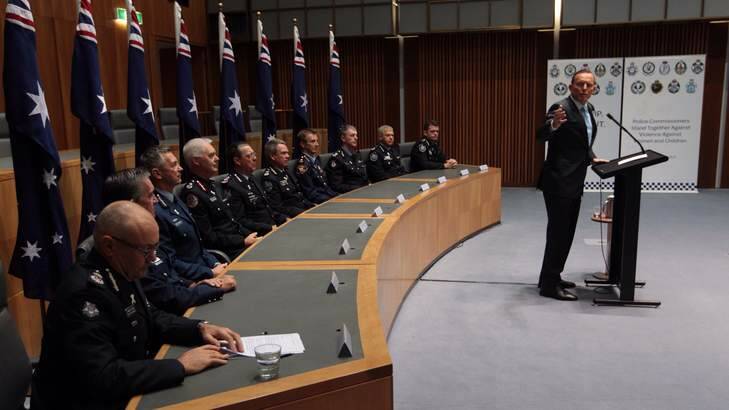Prime Minister Tony Abbott joined Australian and New Zealand police commissioners to stand  against violence against women and children at Parliament House on Monday. Photo: Andrew Meares