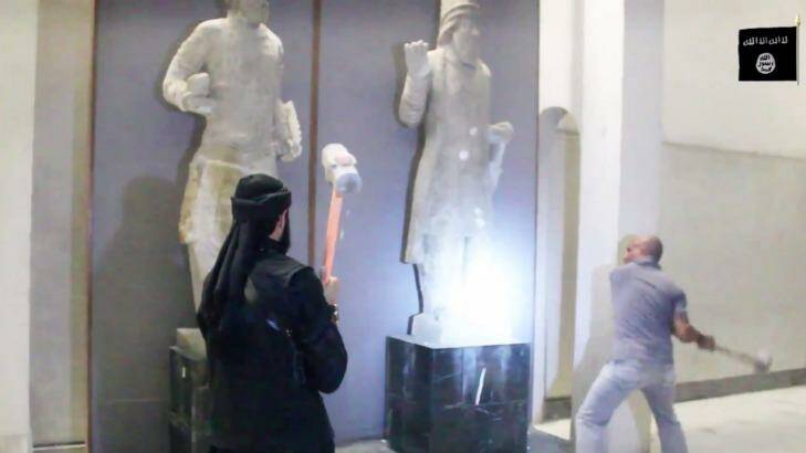 Militants attack ancient artifacts with sledgehammers in the Ninevah Museum in Mosul, Iraq.