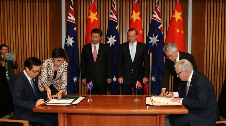 Chinese President Xi Jinping (rear) and then Australian prime minister Tony Abbott witness the signing of the declaration of intent on the Australia-China Free Trade Agreement late last year.