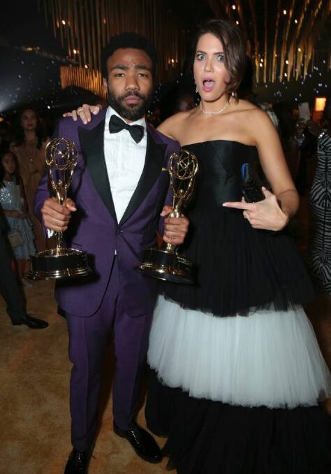 Donald Glover, winner of the awards for outstanding directing for a comedy series for the "Atlanta" episode "B.A.N." and outstanding lead actor in a comedy series for "Atlanta", left, and Mandy Moore attend the Governors Ball for the 69th Primetime Emmy Awards at the Los Angeles Convention Center on Sunday, Sept. 17, 2017, in Los Angeles. (Photo by Alex Berliner/Invision for the Television Academy/AP Images)