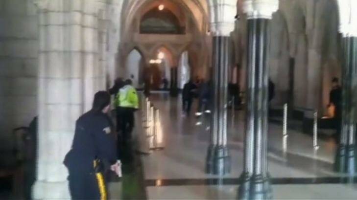Police officers respond to shooting attacks inside the Centre Block of the parliament buildings in Ottawa. Photo: Reuters/The Globe and Mail