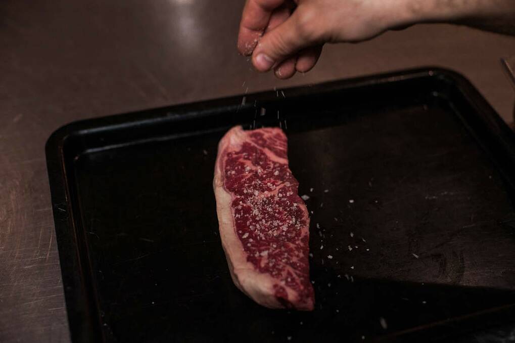 Steak: Step 1: Season each steak with salt and pepper before drizzling with oil or fat. Photo: Josh Robenstone/Getty Images