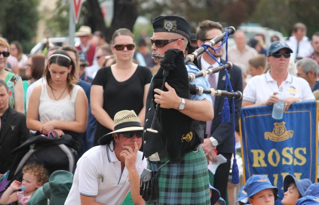 ATTENTION: One of the two pipers who played at this morning's ceremony.