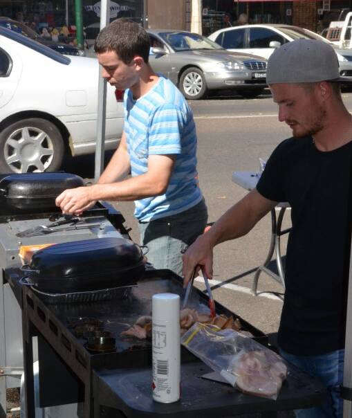 BREAKFAST COOKS: Corey Rynne and Jackson Haussler manned the Telstra barbecue on Tuesday morning.