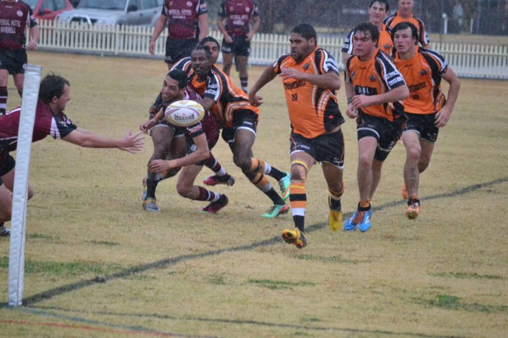 DEFENCE: Harold Duncan passing to Matt Fox right on the try line as Uralla players scramble to prevent the try.