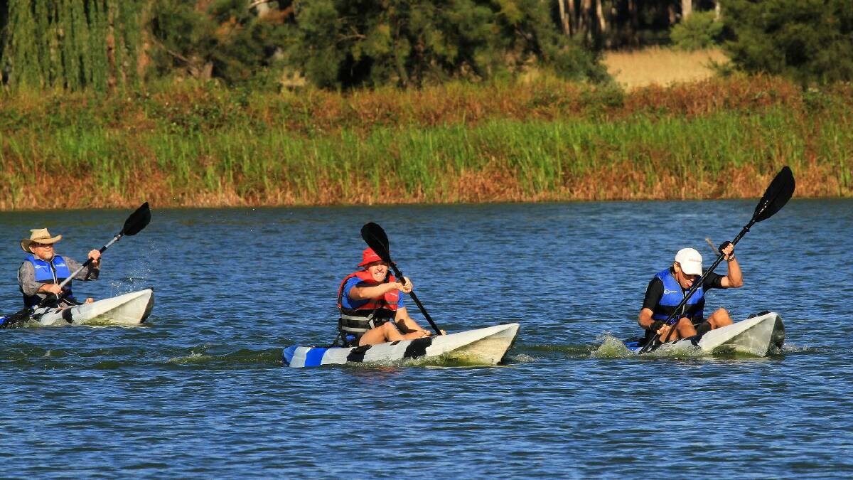 COMPETITION: Andrew Chatterton, Sam Baxter and Glenn Dick battle it out to the finish line on Lake Inverell in the weekend’s Paddlefest.  		
PHOTO by HEINRICH HAUSSLER
