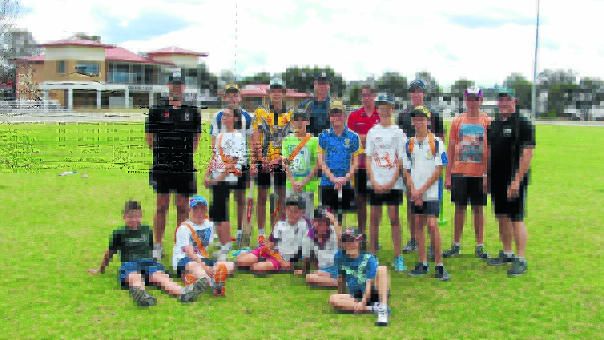 COACHES: Tim and Greg Sparke with the group of junior cricketers.