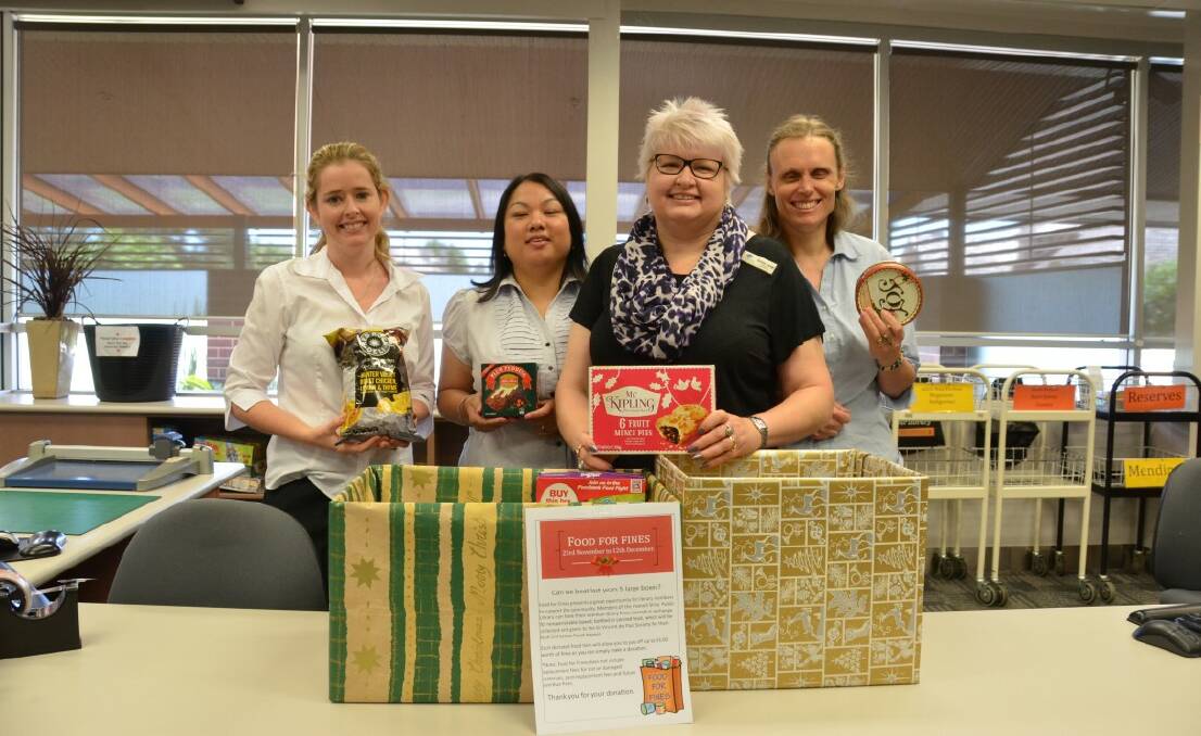 Debbie Simpson, Maria Mutimer, Sonya Lange and Helen Elliot show some of the food items library-goers have donated.