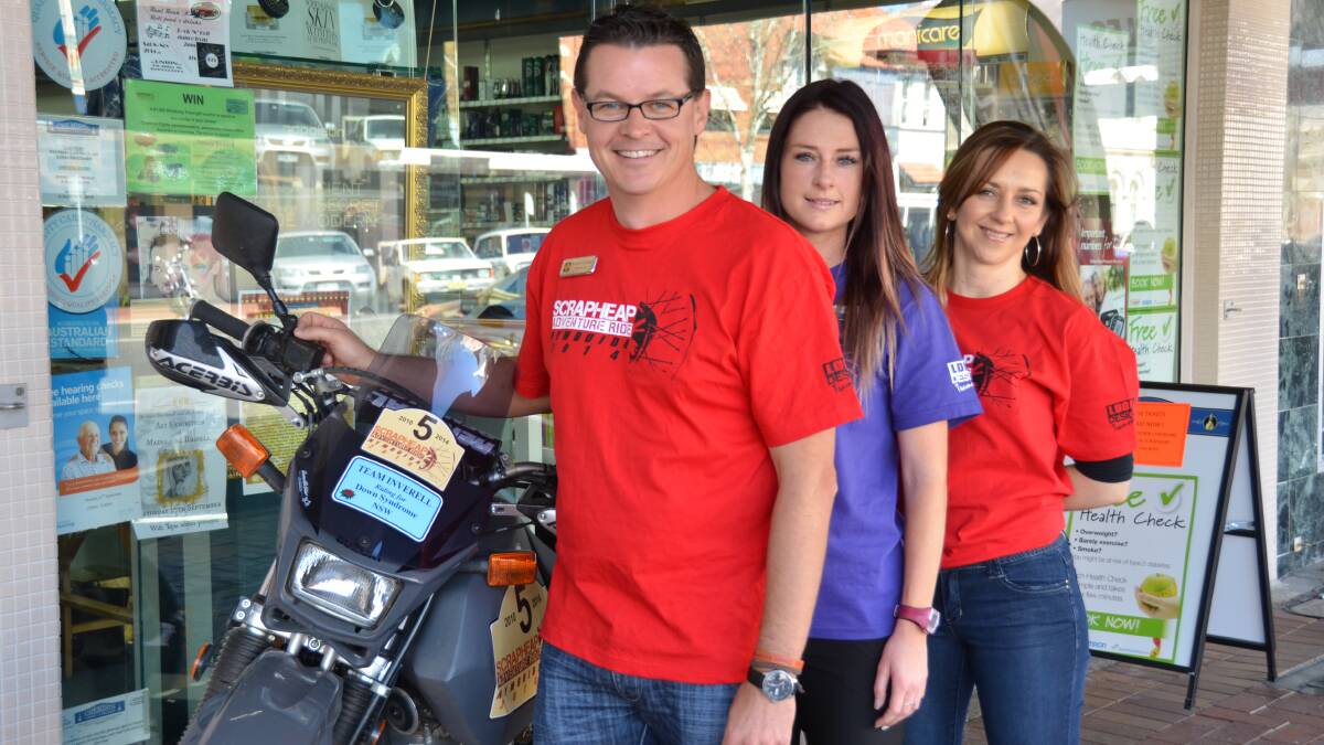 COLLECTING: Brendon Campbell, Ashleigh Falconer and Kerri-Anne Hawkins with the motor bike Brendon says he’ll be cheating on. Tickets in the Scrapheap Adventure Ride raffle were on sale at Campbell and Freebairn Chemist.