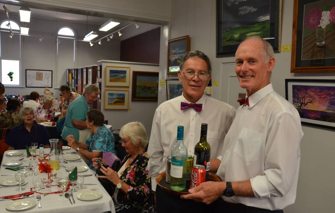 FESTIVE SEASON: Ken Austin and Geoff Johnson keep the glasses full at the Inverell Art Gallery Christmas luncheon.