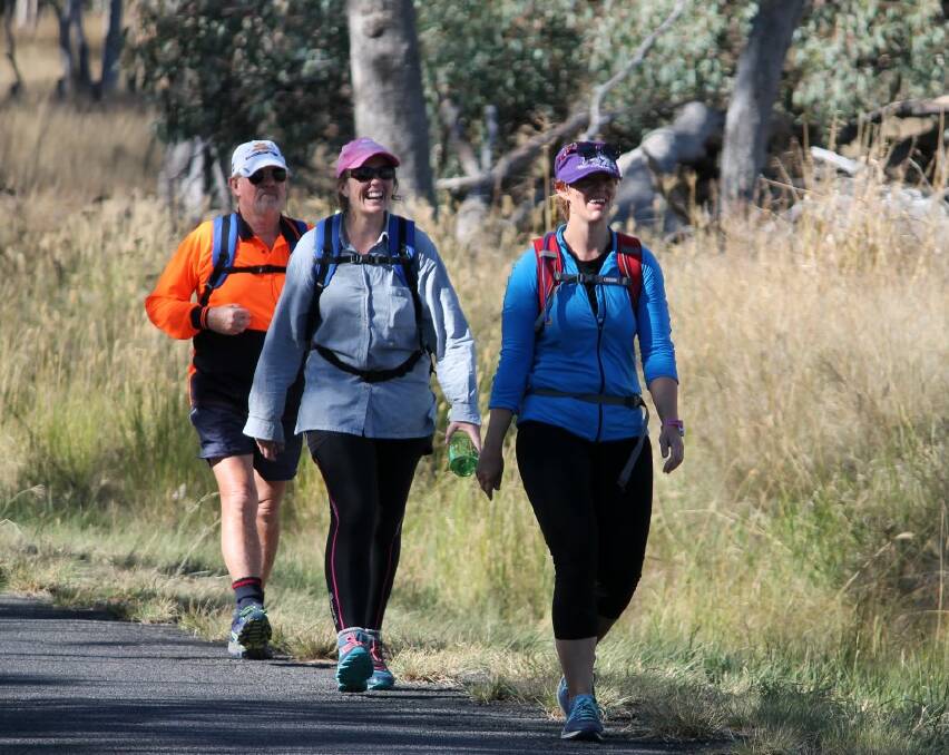 Jaymie Brown (leading), Julie Johnson and Murray Stewart step out the kilometres on the Inverell to Graman road.