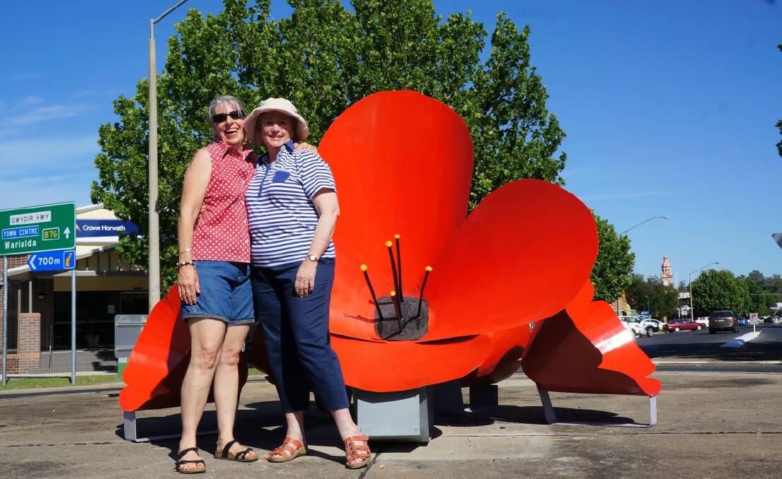 Kurrajong Re-enactment committee president Kim Blomfield with Ann Hodgens following Tuesday's installation of the giant poppies.