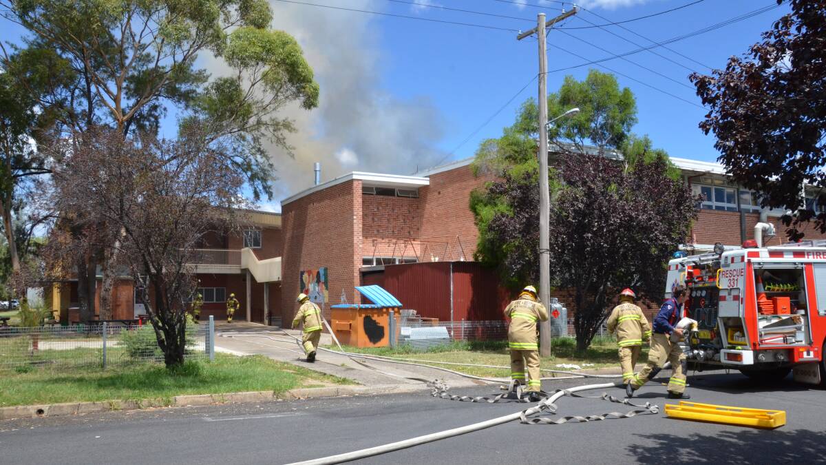 BLAZE: Fire crews arrive at the school's Oswald Street entrance on Wednesday. PHOTO by STEVE GREEN