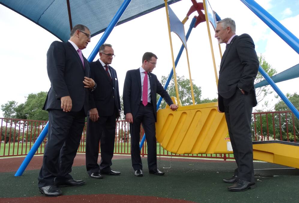 Disability Services Minister John Ajaka, deputy mayor Anthony Michael, Northern Tablelands MP Adam Marshall and mayor Paul Harmon check out the liberty swing.