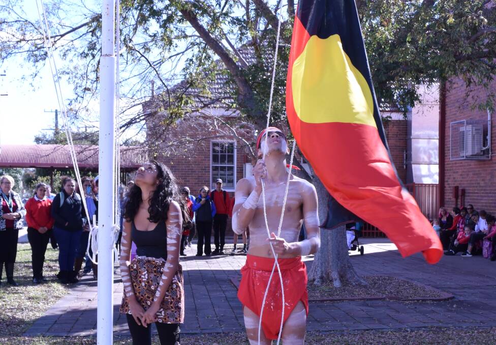 Tamara Jerrard and Dean Davis raised the Aboriginal and Torres Strait Islander flags.
