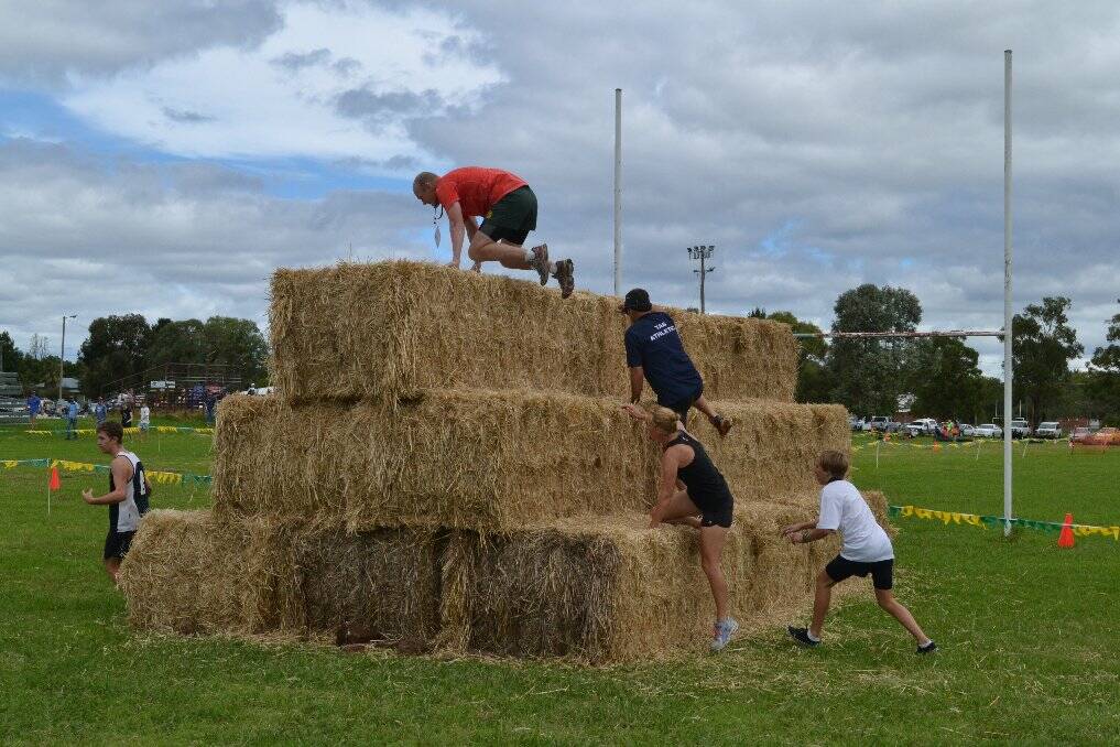 Nigel Henley climbs over the haystack during a previous Toughen Up Challenge at Rugby Park.