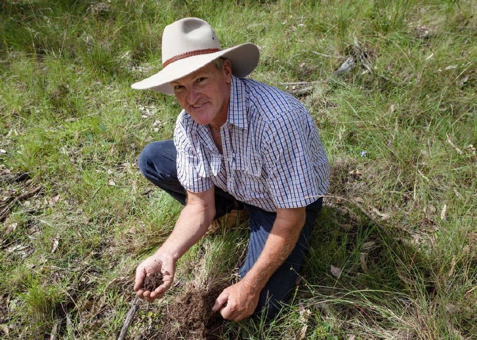 Glenn Morris with a handful of soil on Billabong. Photo courtesy of Bluebottle Films.
