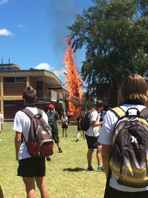 BURNING: A students captured this image of the fire as they were evacuated to the school oval on Wednesday.