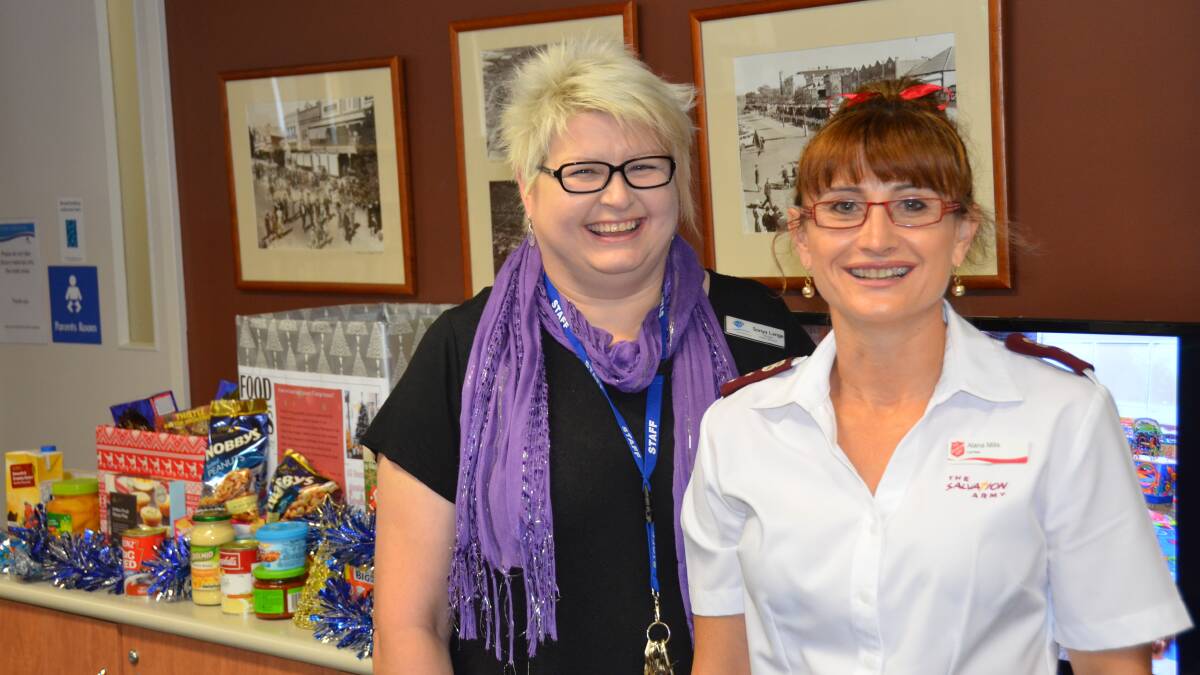 PAYING UP: Library manager, Sonya Lange handed over this year’s donation to the Salvation Army’s Captain Alana Mills, who said this year local farmers are doing it tough.