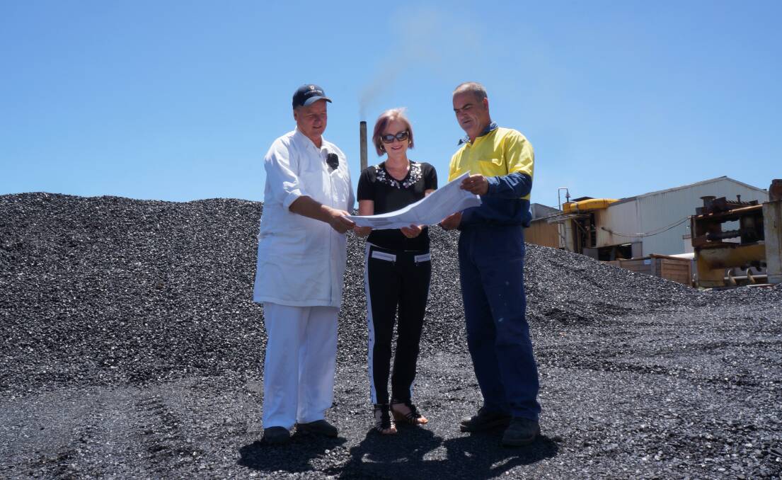 PROJECT TO START IN FEBRUARY: Project engineer Dave Sneddon (right) in front of the bio-digestor plans, with Bindaree Beef plant manager David Richardson, left, and business manager Kerri Newton.
