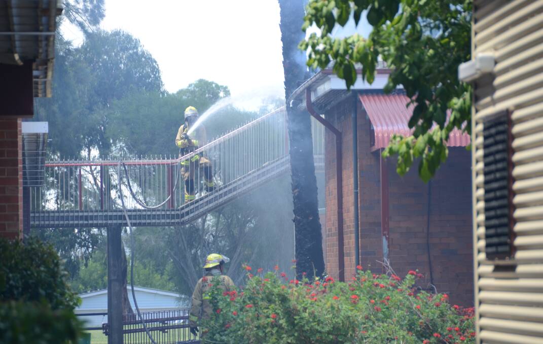 Fire fighters extinguish the blaze at Inverell High School.