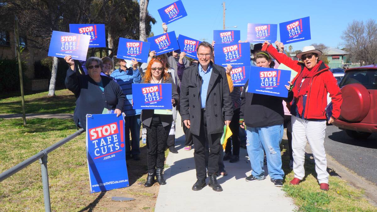RALLY ROUND: Locals stand in support of their TAFE with NSW Greens MP Dr John Kaye (centre) and NSW Teacher’s Federation organiser Kathy Nicholson (right front) on Wednesday in Inverell.