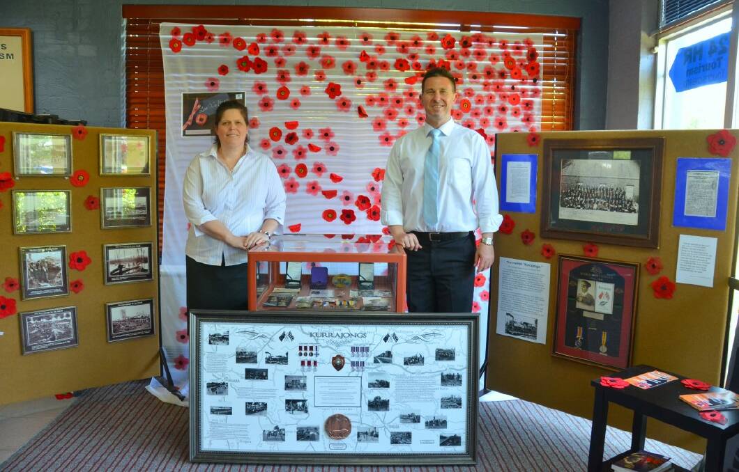 Talia Hill and Peter Caddey with the Never Forgotten exhibition Tourism Inverell staff created.