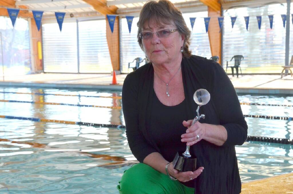 RECOGNITION: Pam Weste displays the award she calls ‘her girl’, a statuette from Swimming NSW in recognition of her FINA listing.